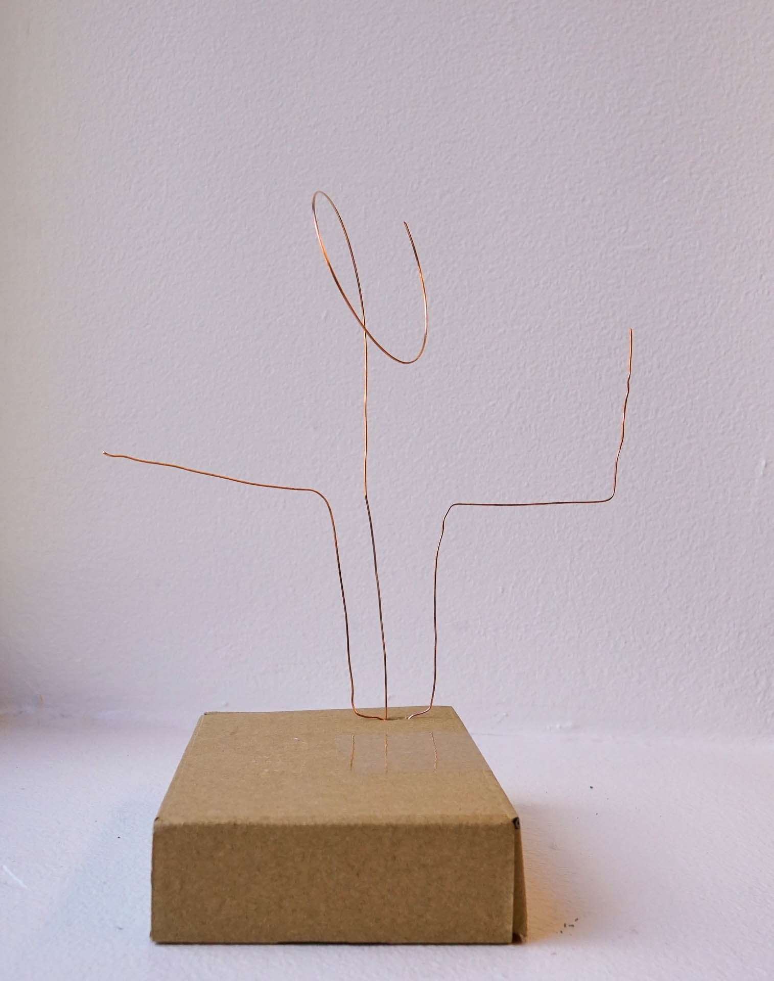 image of second prototype, which is a small brown cardboard box, with 3 copper antennas sticking out from one end